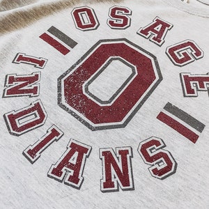 May include: Gray sweatshirt with a maroon and gray graphic that says "Osage Indians" with a large maroon "O" in the center.