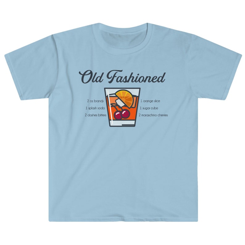 May include: Light blue t-shirt with a graphic of an Old Fashioned cocktail recipe. The recipe includes 2 oz brandy, 1 splash soda, 2 dashes bitters, 1 orange slice, 1 sugar cube, and 2 maraschino cherries.
