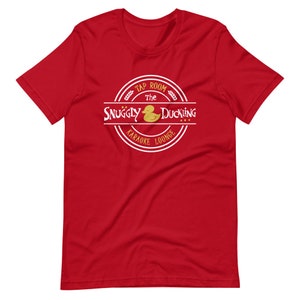 May include: Red t-shirt with a white circle logo that says "The Snuggly Duckling Tap Room Karaoke Lounge" with a yellow rubber duck inside the circle.