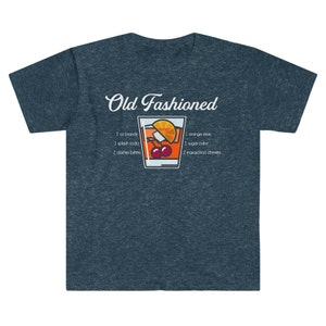 May include: A dark blue t-shirt with a white graphic of an Old Fashioned cocktail recipe. The graphic includes a glass of the cocktail with an orange slice, cherries, and a sugar cube. The text reads "Old Fashioned" and lists the ingredients: 2 oz brandy, 1 splash soda, 2 dashes bitters, 1 orange slice, 1 sugar cube, 2 maraschino cherries.