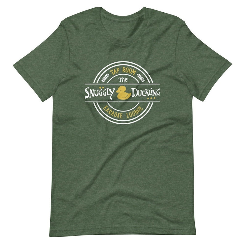 May include: Green t-shirt with a white circle logo that says "The Snuggly Duckling Tap Room Karaoke Lounge" with a yellow rubber duck inside the circle.