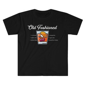 May include: Black t-shirt with white text that reads "Old Fashioned" and a graphic of an Old Fashioned cocktail with the ingredients listed below: 2 oz brandy, 1 splash soda, 2 dashes bitters, 1 orange slice, 1 sugar cube, 2 maraschino cherries.