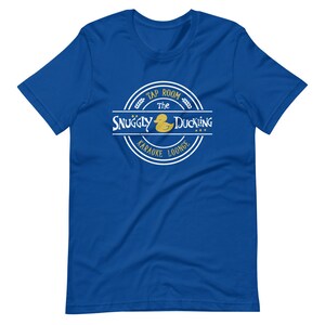 May include: Blue t-shirt with a white circle logo that says "The Snuggly Duckling Tap Room Karaoke Lounge" with a yellow rubber duck inside the circle.