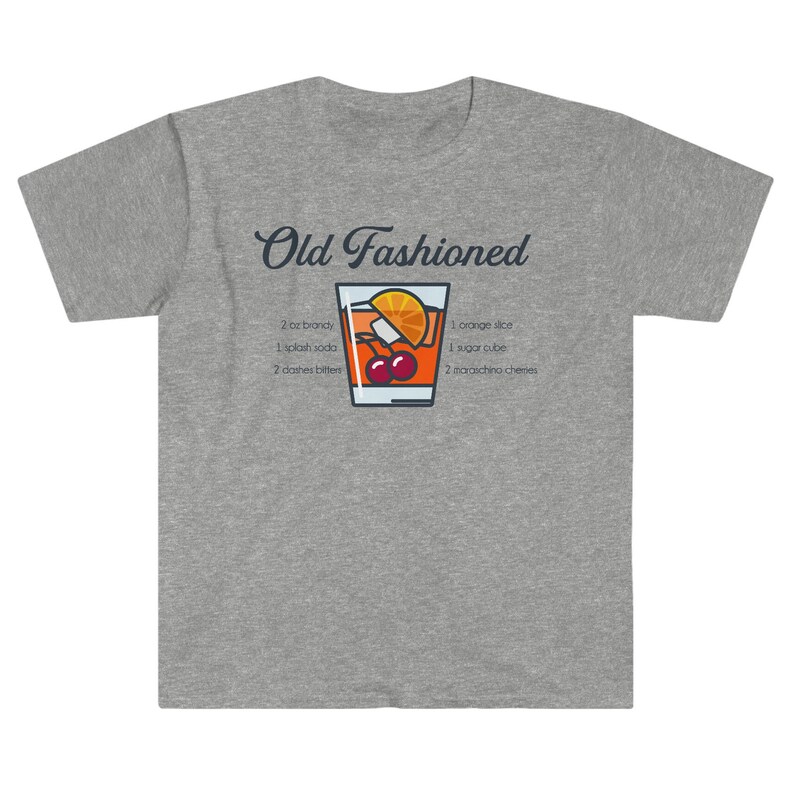 May include: A gray t-shirt with a graphic of an Old Fashioned cocktail recipe. The recipe includes 2 oz brandy, 1 splash soda, 2 dashes bitters, 1 orange slice, 1 sugar cube, and 2 maraschino cherries.
