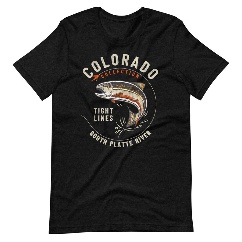 May include: Black t-shirt with a white circle graphic featuring a trout jumping out of the water. The circle graphic says "Colorado Collection", "Tight Lines", and "South Platte River".