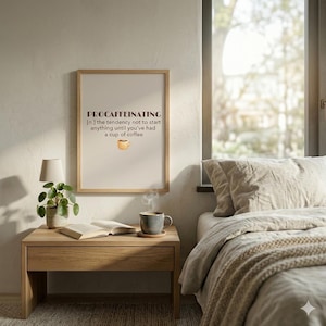 May include: A framed print with the word "PROCAFFEINATING" and the definition: "the tendency not to start anything until you've had a cup of coffee." A coffee cup illustration is below the text. The print hangs above a wooden nightstand.