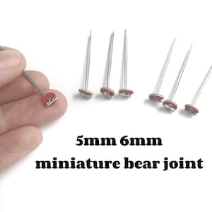 May include: Close-up of several miniature bear joints. The joints have a red disc with a metal pin. The text on the image reads "5mm 6mm miniature bear joint".