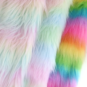May include: A close-up of a rainbow-colored faux fur fabric. The fur is soft and fluffy, with shades of pink, blue, green, and yellow.
