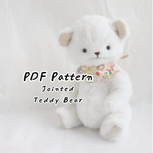May include: A white plush teddy bear with jointed limbs, dark eyes, and a small nose. The bear wears a colourful floral patterned neck scarf. The text "PDF Pattern Jointed Teddy Bear" is displayed on the left side of the image in black font.