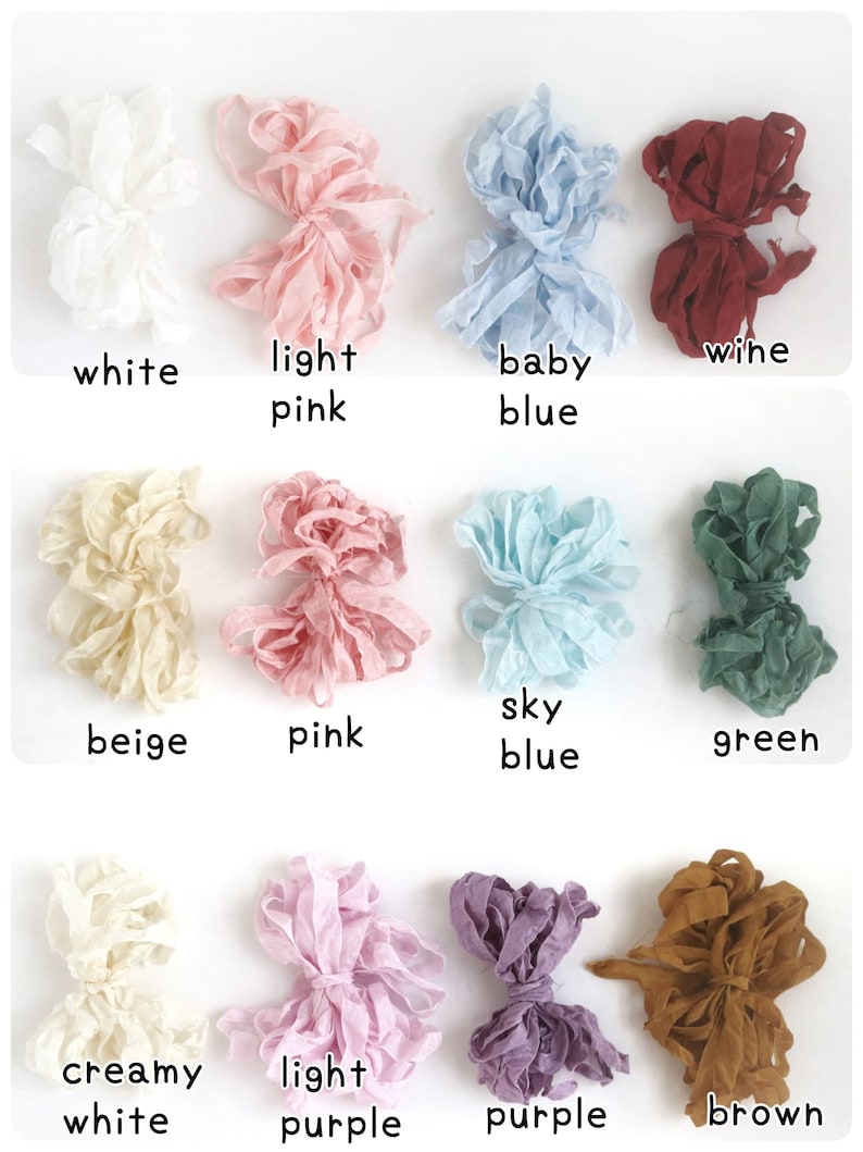 May include: A collection of 12 spools of ribbon in various colors, including white, light pink, baby blue, wine, beige, pink, sky blue, green, creamy white, light purple, purple, and brown.