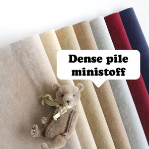 May include: A variety of colors of dense pile ministoof fabric. The fabric is soft and plush, and it is perfect for making teddy bears, blankets, and other crafts. The fabric is shown with a small teddy bear.