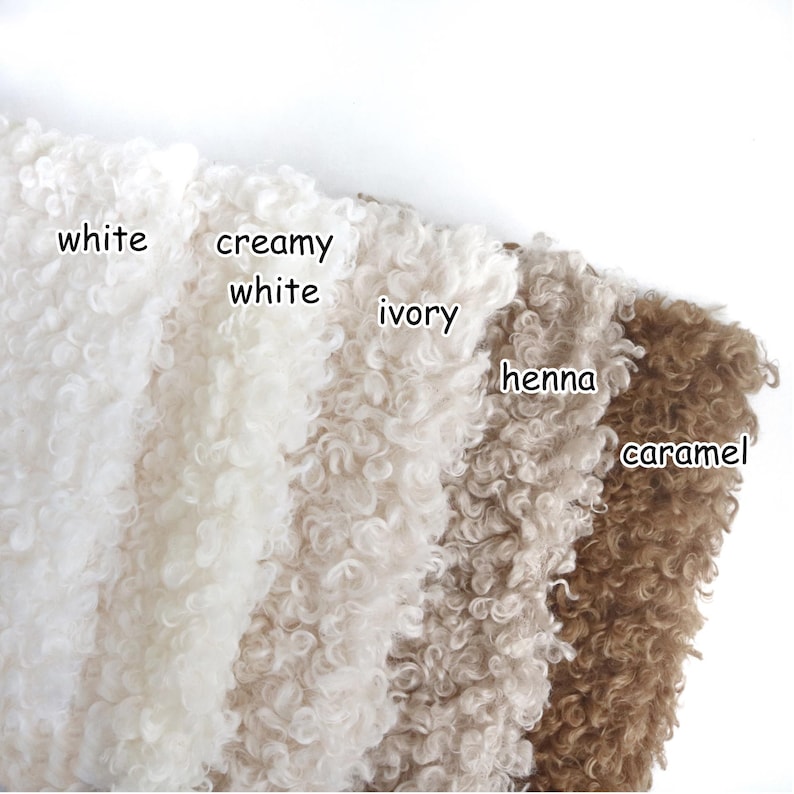 May include: Five swatches of curly, textured fabric arranged side by side. The colors are labeled as white, creamy white, ivory, henna, and caramel. Each section displays a dense, looped pile surface with a consistent, uniform appearance.