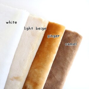 May include: Four fabric swatches in different shades of beige, from white to camel. The swatches are labeled "white", "light beige", "ginger", and "camel".