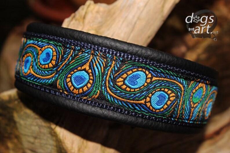 May include: A black leather dog collar with a blue, green, and gold peacock feather pattern.