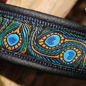 May include: A black leather dog collar with a peacock feather pattern in blue, green, and gold.