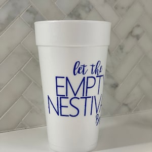 May include: White foam cup with blue lettering that reads "let the empty nest begin".