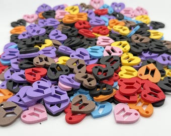 May include: A large collection of small, heart-shaped charms in various colors including red, yellow, orange, purple, pink, blue, black, and brown. Each charm features a cutout of the BTS logo in the center and a small hole for attachment.