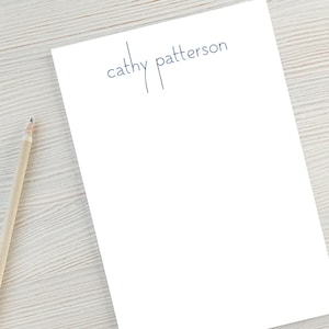 May include: A white notepad with the text "cathy patterson" printed in blue ink.