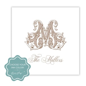 May include: A square white card featuring a large, ornate, brown letter M monogram with intricate scrollwork details. Below the monogram, the text The Millers is printed in a brown script font. A teal scalloped badge with the text CHOOSE YOUR INK COLOR! and shoo fly paper co. is overlaid in the bottom left corner.