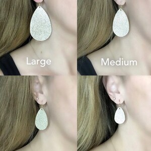 May include: Four pairs of teardrop-shaped leather earrings in different sizes: large, medium, small, and mini. The earrings are a light cream color with a subtle shimmer.