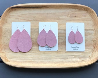 May include: Three pairs of pink leather teardrop earrings displayed on white cards with the text "Designed by Tammi" on each card.