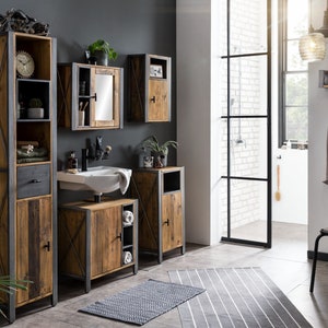 May include: A rustic bathroom set featuring wooden cabinets with metal frames. The set includes a tall cabinet, a vanity with a sink, and wall-mounted cabinets. A gray rug and a neutral-colored bathrobe complete the bathroom decor. A decorative motorcycle model sits atop the tall cabinet.