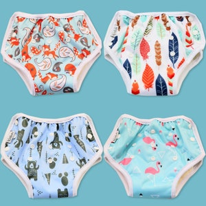 May include: Four different patterned swim nappies for babies. The nappies are blue with various patterns including foxes, feathers, bears, and flamingos.