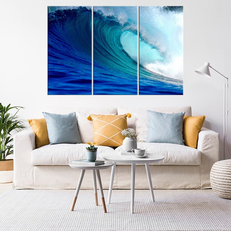 May include: A three-piece canvas print set featuring a large blue wave crashing in the ocean. The wave is a vibrant blue and green color, with white foam at the crest. The print is perfect for adding a touch of nature to any room.