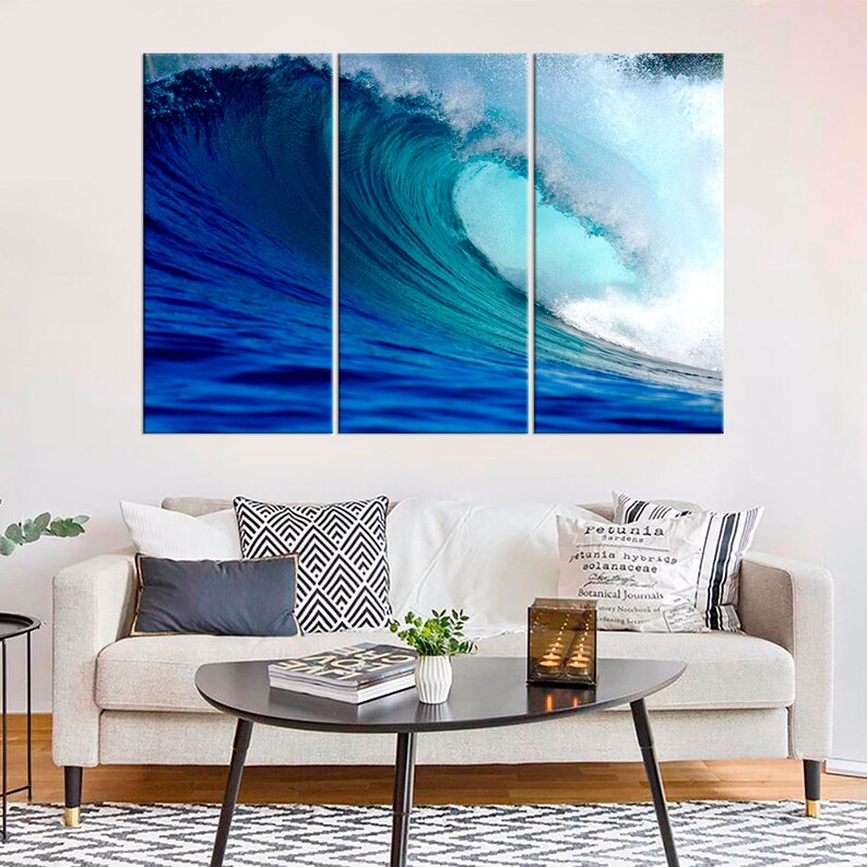 May include: A three-panel canvas print featuring a large, blue ocean wave crashing. The wave is turquoise blue and white with a deep blue background.