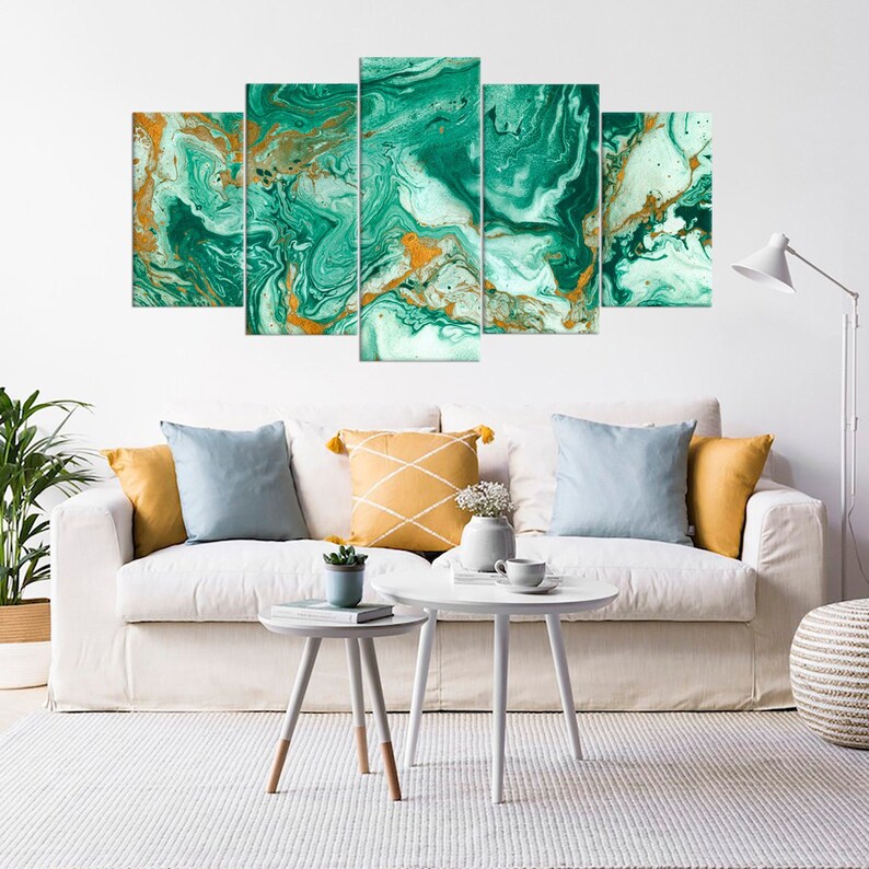 May include: A five-piece canvas wall art set featuring an abstract green and gold marble design. The artwork is displayed on a white wall above a white couch with pillows.