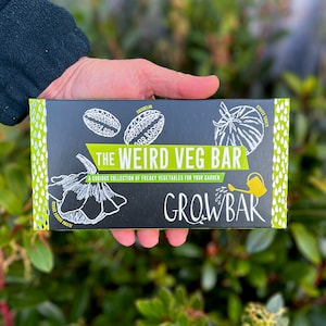 May include: A black box with a green border and white text that reads "The Weird Veg Bar: A Curious Collection of Freaky Vegetables for Your Garden" and "Growbar".