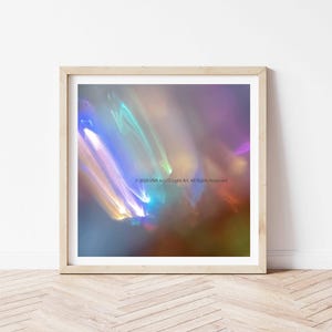 May include: Abstract art print in a light wooden frame. The artwork features a blurred, colorful design with streaks of blue, yellow, and purple. The text "© 2020 VIVA la LUZ Light Art. All Rights Reserved" is visible.