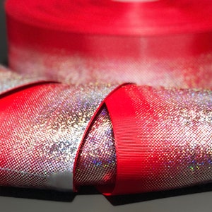 May include: Red ribbon with iridescent silver glitter, folded into a bow shape.