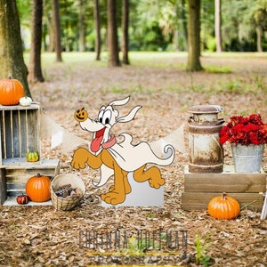 May include: A cartoon dog dressed as a ghost with a pumpkin on its head stands in a fall-themed scene with pumpkins, crates, and a rustic milk can.