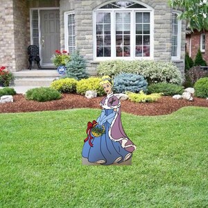May include: A cartoon illustration of Cinderella in a blue dress and purple cape holding a basket of flowers. The illustration is standing on a green lawn in front of a house.