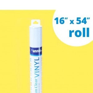 May include: A roll of clear vinyl, 16 inches wide and 54 inches long, against a yellow background. The label reads "Premium Clear Vinyl" with the brand name "annie". The roll is white with blue and black accents.