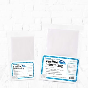 May include: A white package of fusible interfacing fabric. The package is labeled "Fusible Interfacing" and lists the product's features: adds strength, body, and crispness to woven and knit fabrics, stabilizes pockets and borders, and can be used as a backing for needlework. The package is 5 yards long.