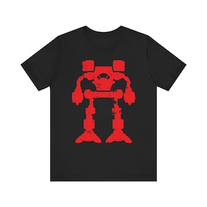 May include: Black t-shirt featuring a distressed red graphic of a bipedal robot. The robot design has a blocky, industrial aesthetic, with visible details like a cockpit and articulated limbs. The shirt is made of a soft material.