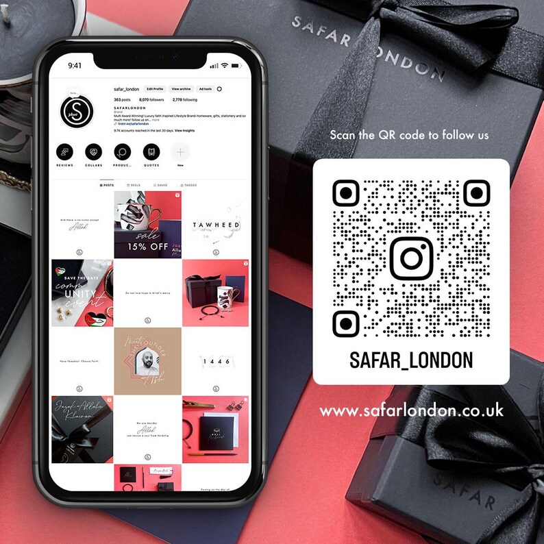 May include: A screenshot of a mobile phone displaying a social media profile for a company called "Safar London". The profile features a grid of nine images, including a sale announcement, a logo, and a product image. The phone is on a red surface with a black box and a QR code that says "Scan the QR code to follow us" and "SAFAR_LONDON". Below the QR code is the text "www.safarlondon.co.uk".