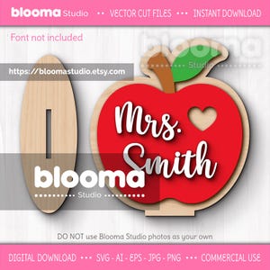 May include: Wooden teacher appreciation sign. The design features a red apple with a heart and the name "Mrs. Smith" in white script. Includes a wooden stand with the word "blooma" and a slot for a name. Vector cut files.
