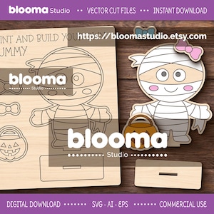 Puede incluir: Archivos de corte vectorial de madera para un proyecto de manualidades de Halloween con temática de momias. El diseño incluye una figura de momia, una cesta de calabaza y un lazo. El texto "PAINT AND BUILD YOUR MUMMY" es visible. Descarga digital.
