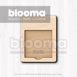 May include: A light-colored wooden frame with a rectangular cutout and a curved bottom edge. The frame has the text "blooma Studio" at the top and bottom. The background is a light wood grain.
