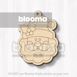 May include: A wooden Santa Claus ornament with a hat, beard, and holly detail. The ornament has a hole at the top for hanging. The text "blooma studio" is visible on the image. The bottom of the image reads "DO NOT use Blooma Studio photos as your own".
