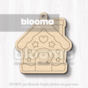 May include: A wooden house-shaped ornament with a heart and star design. The ornament has a chimney and a door. The text "blooma Studio" is visible at the top. The bottom of the image reads "DO NOT use Blooma Studio photos as your own".