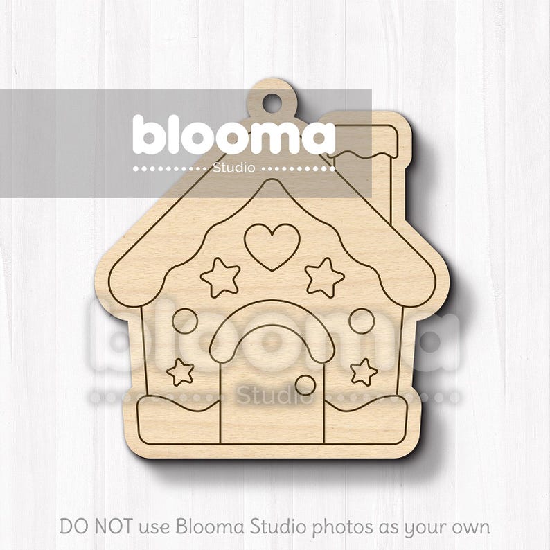 May include: A wooden house-shaped ornament with a heart and star design. The ornament has a chimney and a door. The text "blooma Studio" is visible at the top. The bottom of the image reads "DO NOT use Blooma Studio photos as your own".