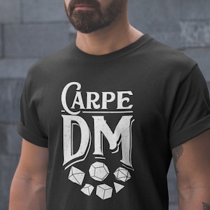 May include: Black t-shirt with white text that reads "Carpe DM" and a graphic of dice.