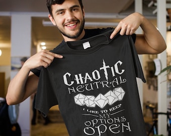 May include: A black t-shirt with white text that reads "Chaotic Neutral I like to keep my options open". The text is in a stylized font and includes a graphic of four dice.