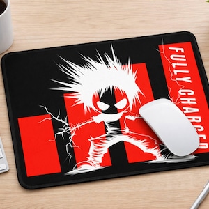 May include: Black mousepad with a red and white graphic of a cartoon character with the text "FULLY CHARGED". A white computer mouse is on the mousepad. The mousepad is on a wooden desk.