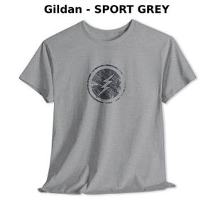 Distressed lightning bolt graphic t-shirt with circular emblem printed on ringer and classic cotton tees in multiple color options