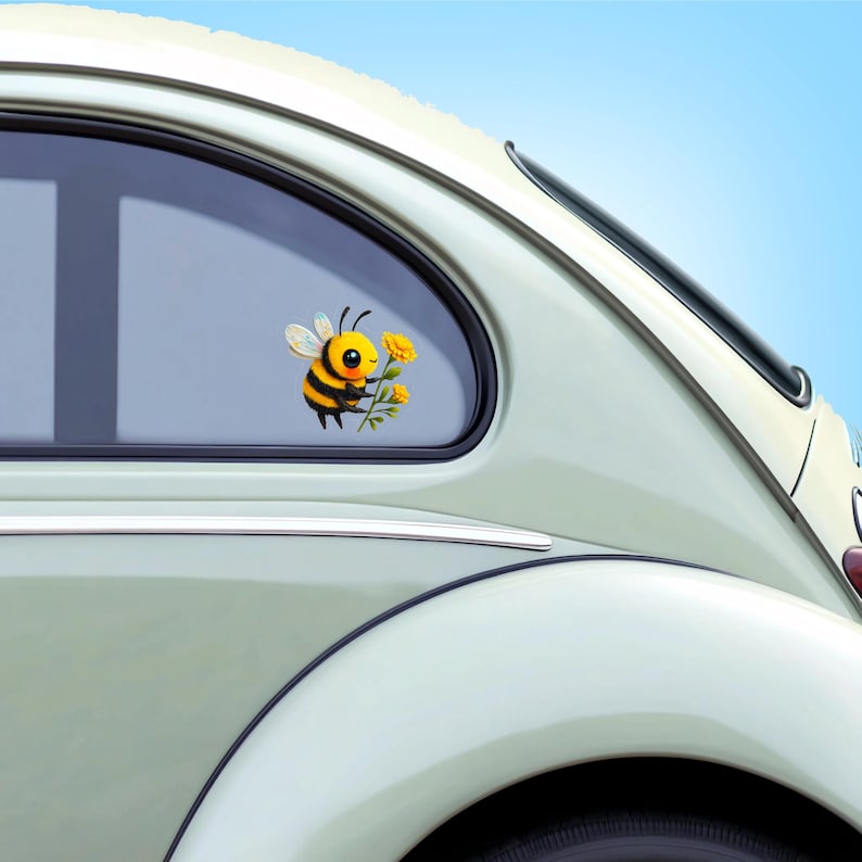Adorable die-cut vinyl design of a fuzzy yellow honeybee holding a bright yellow flower. Shown as a fridge magnet displayed on a stainless steel refrigerator. This design is also available as a waterproof transparent sticker in five sizes. Ideal for decorating laptops, journals, water bottles, fridges, and more. Suitable for indoor and outdoor use.
